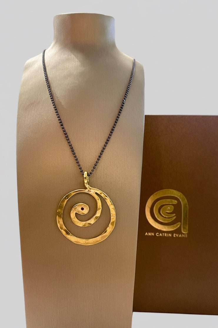 Brass swirl pendant